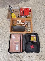 overall view of lot showing drop light, socket sets, first aid kit, hand tools