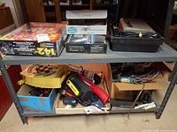 Overall lot on two-shelf rack showing all items