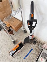 Assembled Worx string trimmer, boxed second unit, accessories and manuals