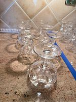Group of seven Waterford stemmed glasses upright and inverted on countertop