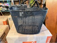 Front view of black metal mesh bicycle basket