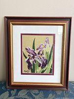 Front view of framed bunka embroidery showing iris design, matting and frame