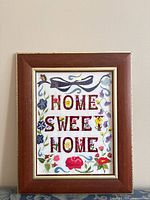 Front view showing embroidered design, frame, text