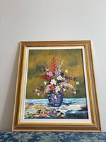 Frontal view of framed oil floral painting