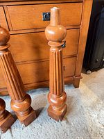 Full view of one leg showing fluted column, square base, threaded rod