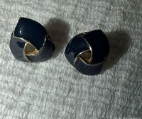 Front view of both enamel earrings showing swirl design