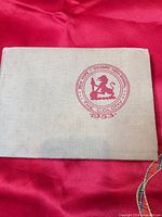 Front cover showing linen cloth and red school crest