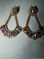 Front view of both earrings showing crystals, pearls and chain detail