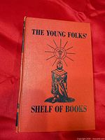 Front cover showing title and knight illustration on red cloth