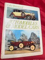Front cover showing title and two automobile images