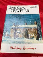 Front cover showing magazine title, winter scene artwork, Holiday Greetings text