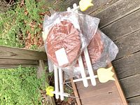 Sealed plastic stepping stones stacked with edging pieces visible