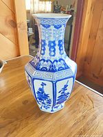 Full view of vase showing blue floral panels and geometric border