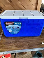 Front view of blue Coleman 48 qt cooler showing capacity label