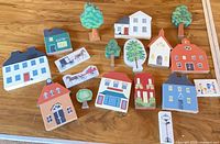 Group of wooden houses, trees, scene blocks arranged on tabletop
