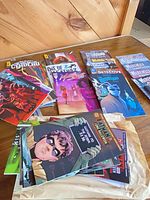 Stack of assorted comics spread on table