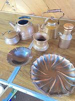 Group shot of all seven copper items on table