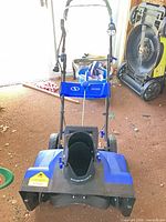 Front view of Snow Joe electric snow thrower showing chute, wheels, handle and light