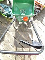 Top view Scotts spreader hopper, handle, partial reel mower visible