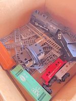 Box overview showing locomotive, tender, three freight cars, track sections and transformer