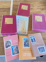 Five magenta boxes, one open showing contents, and three Nature Program booklets