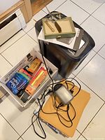 Overview of shredder, envelopes, sharpener and box of supplies