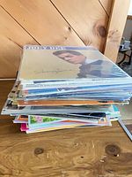 Stack of vinyl LPs on table, top album Joey Dee