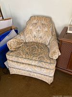 Full view of upholstered club chair showing overall design and condition