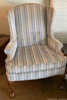 Front view of striped wingback chair