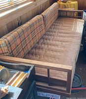 Full top view of wood frame sofa with plaid cushions