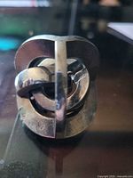 Front view of chrome-plated metal puzzle