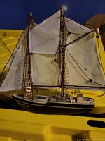 Full view starboard side showing hull color, masts and sails