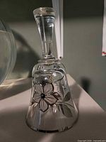 Full view of crystal bell showing floral design and handle