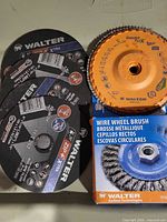 Group of three black Zip+ Xtra wheels, one orange flap disc, boxed wire wheel brush