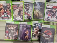 Overall view of nine visible Xbox 360 game cases laid out