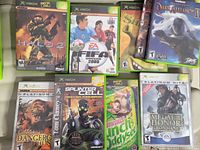 Group shot of seven Xbox game cases showing title fronts