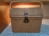 Full view of wicker picnic basket showing shape, handle and lid