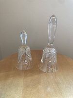 Two cut lead crystal bells on table