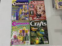 Four crafting magazines laid out on table
