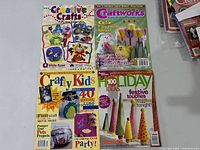 Front covers of four children’s craft booklets laid flat