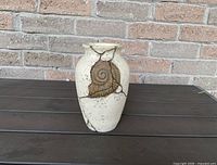 Front view of cream faux soapstone vase with fossil detail