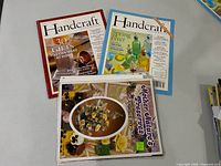 Three craft publications displayed: two Handcraft issues and Mother Nature’s Preserves booklet