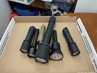 All six flashlights displayed in box lid