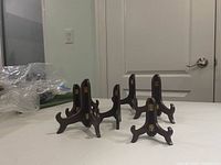 five assembled wooden easels on table