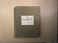 Front view of hardcover book with olive dust jacket and title label