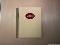 Front cover of beige hardcover book with red title oval