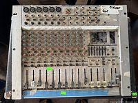 Front view of Behringer MX1804X mixer showing all faders, knobs and inputs