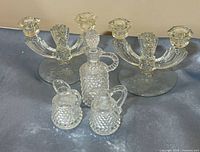 full lot view showing two candelabras and three hobnail items