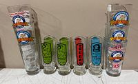 Full set of ten printed pint glasses lined up