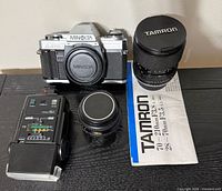 Overall lot showing Minolta X-370 body, Tamron zoom lens, Minolta prime lens, flash, Tamron manual